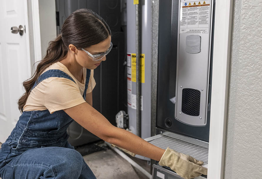 Woman changing furnace filter