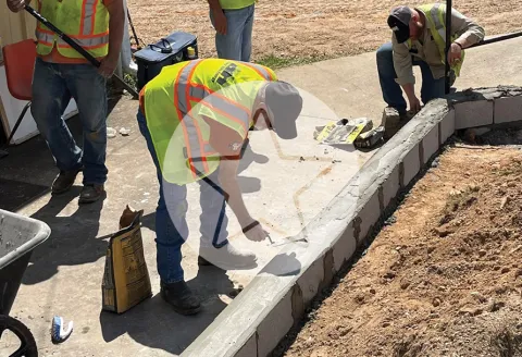 Workers pouring concrete
